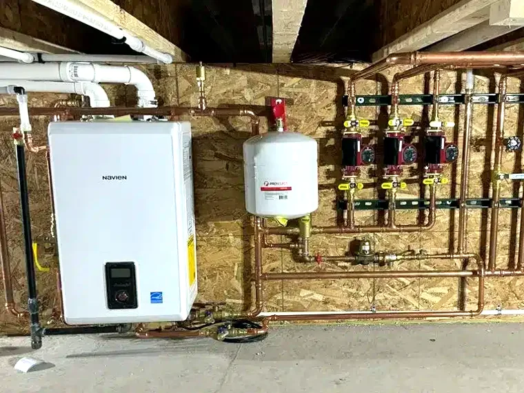 Wall-hung combi boiler with clean copper manifold installed by Advantage Air