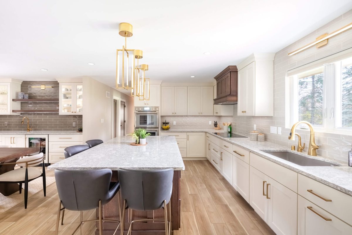 Bright kitchen remodel with brass pendants