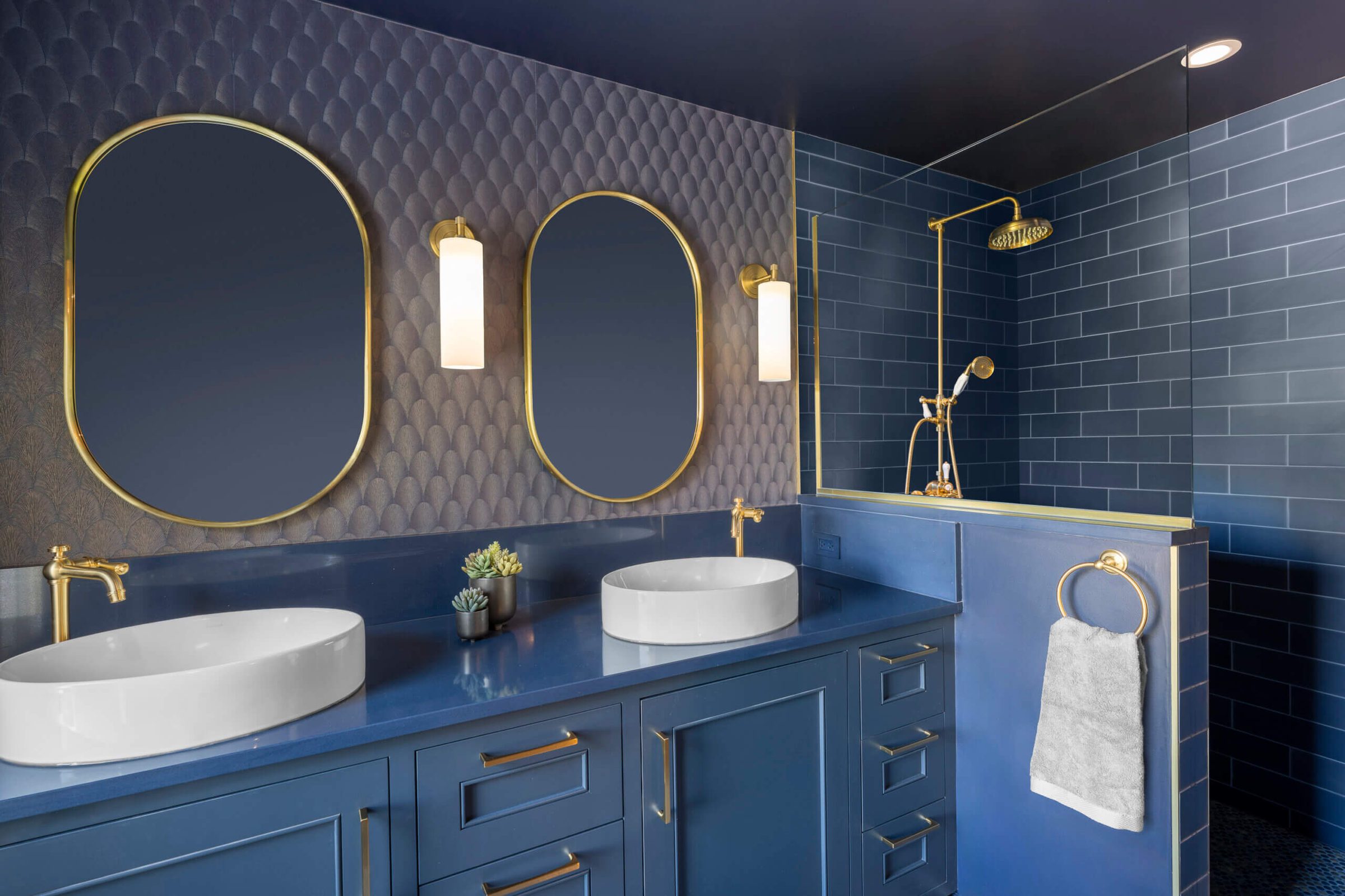 Navy and brass primary bathroom remodel by Advantage Design + Remodel