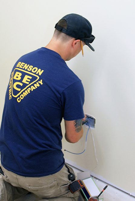 Benson Electric electrician wiring a residential outlet