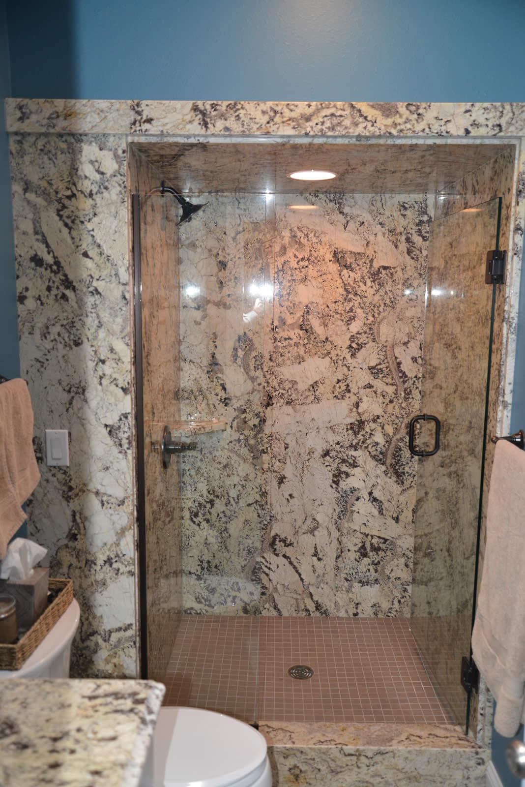 Floor-to-ceiling natural stone shower surround