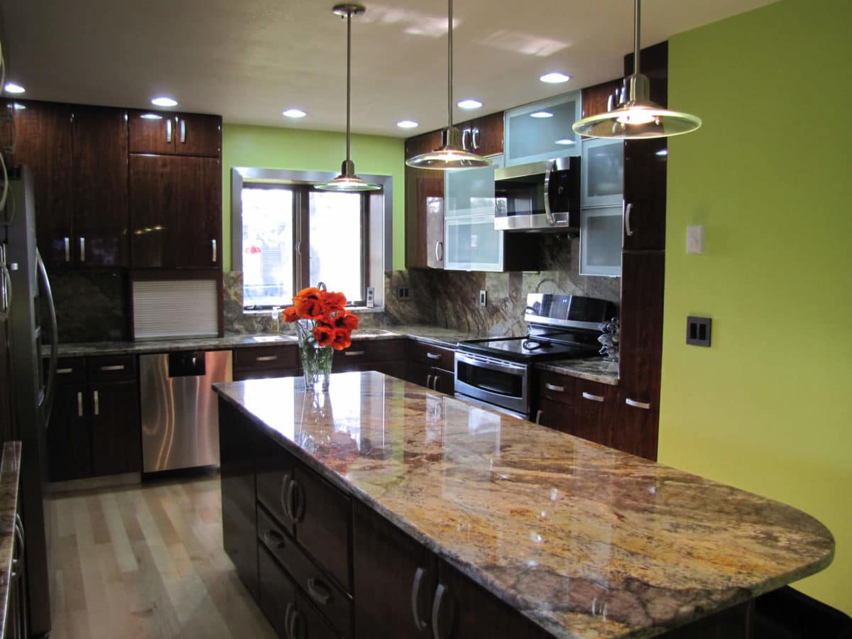 Granite island countertop with dramatic movement in a remodeled kitchen