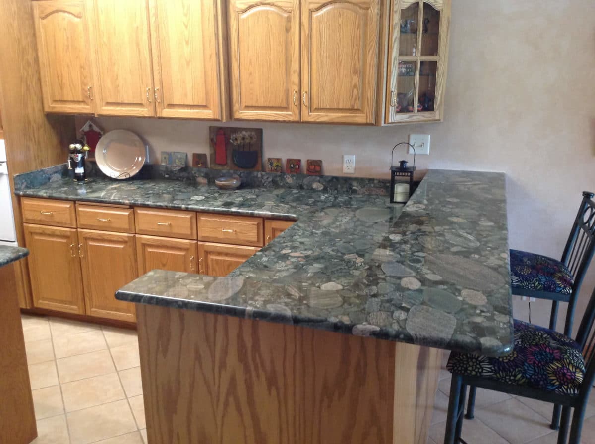 Green natural stone countertops with matching bar top