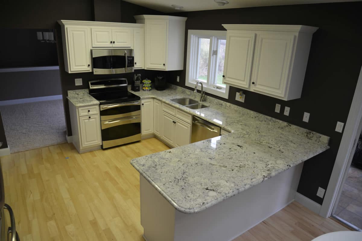 White cabinet kitchen with new stone countertops