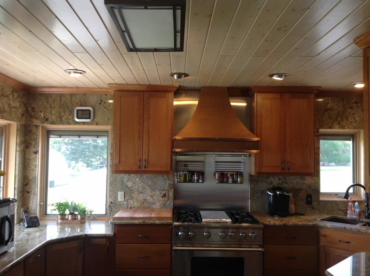 Kitchen with full-height natural stone backsplash walls