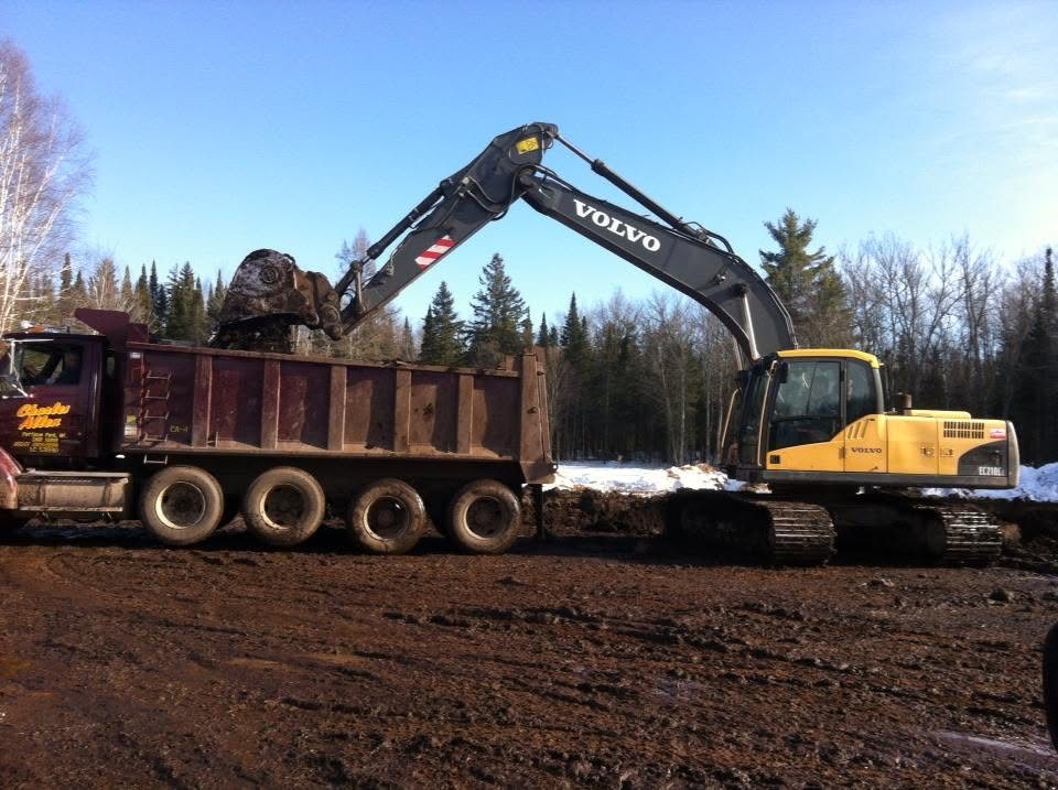 Volvo excavator loading a dump truck on a Superior WI job site
