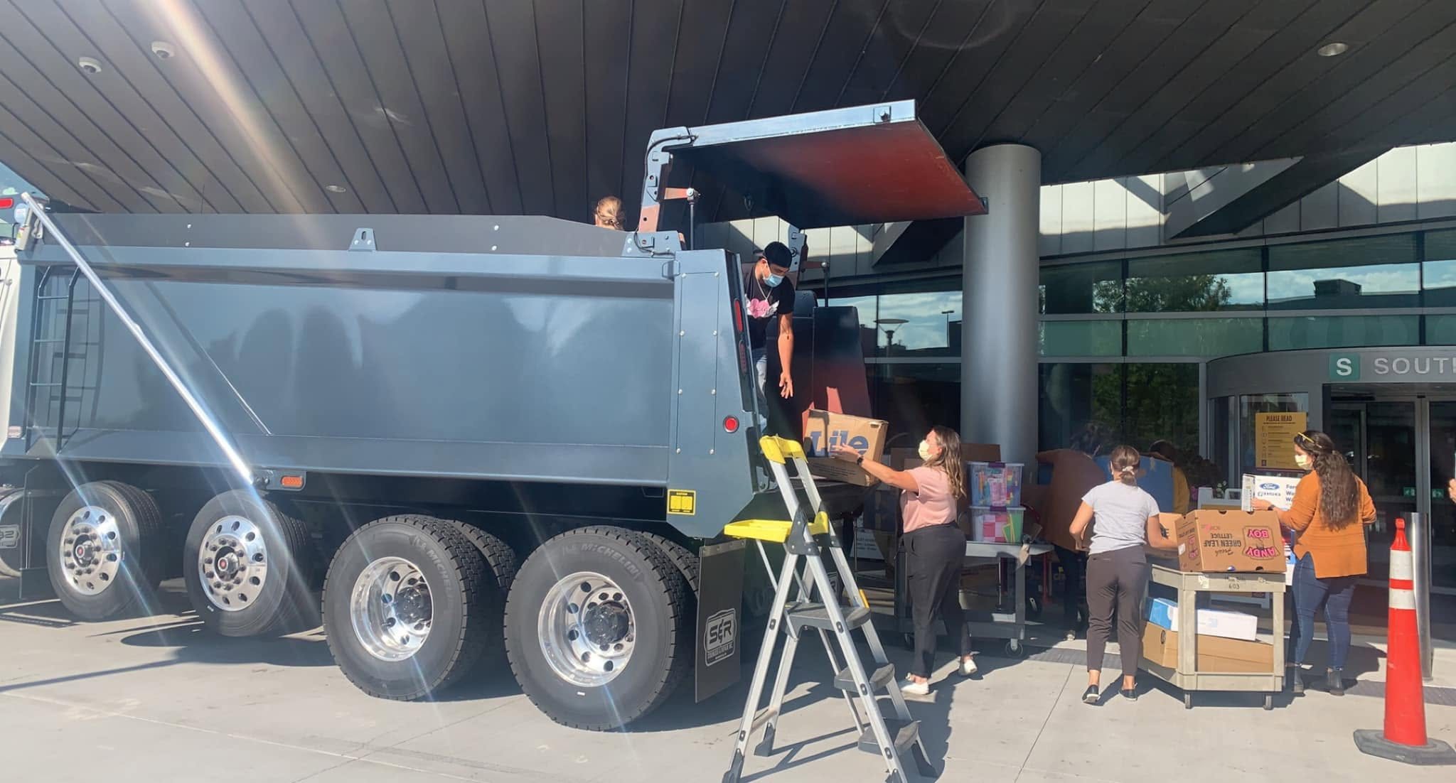 Joe Kimmes Construction crew delivering a dump truck full of donations