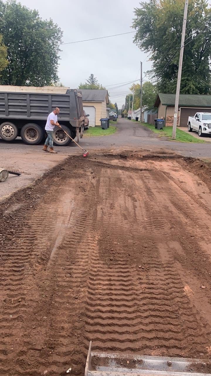 Street-side grading with dump truck