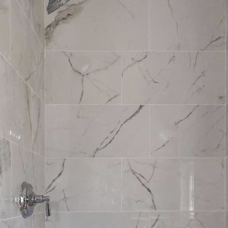 Large format marble effect tile in a finished shower