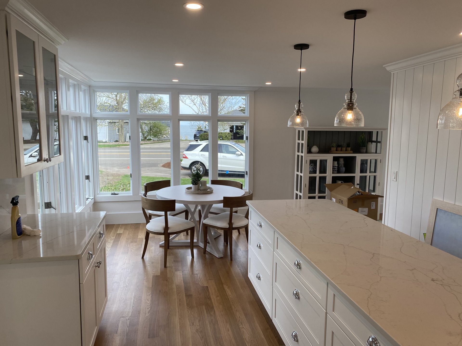 Renovated kitchen with a long island, quartz counters and a bay window