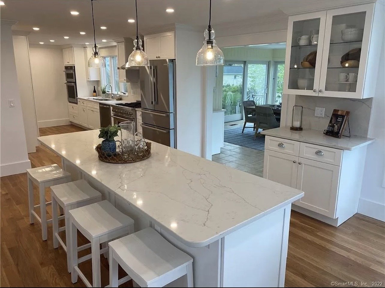 Kitchen with glass-front cabinetry and an island