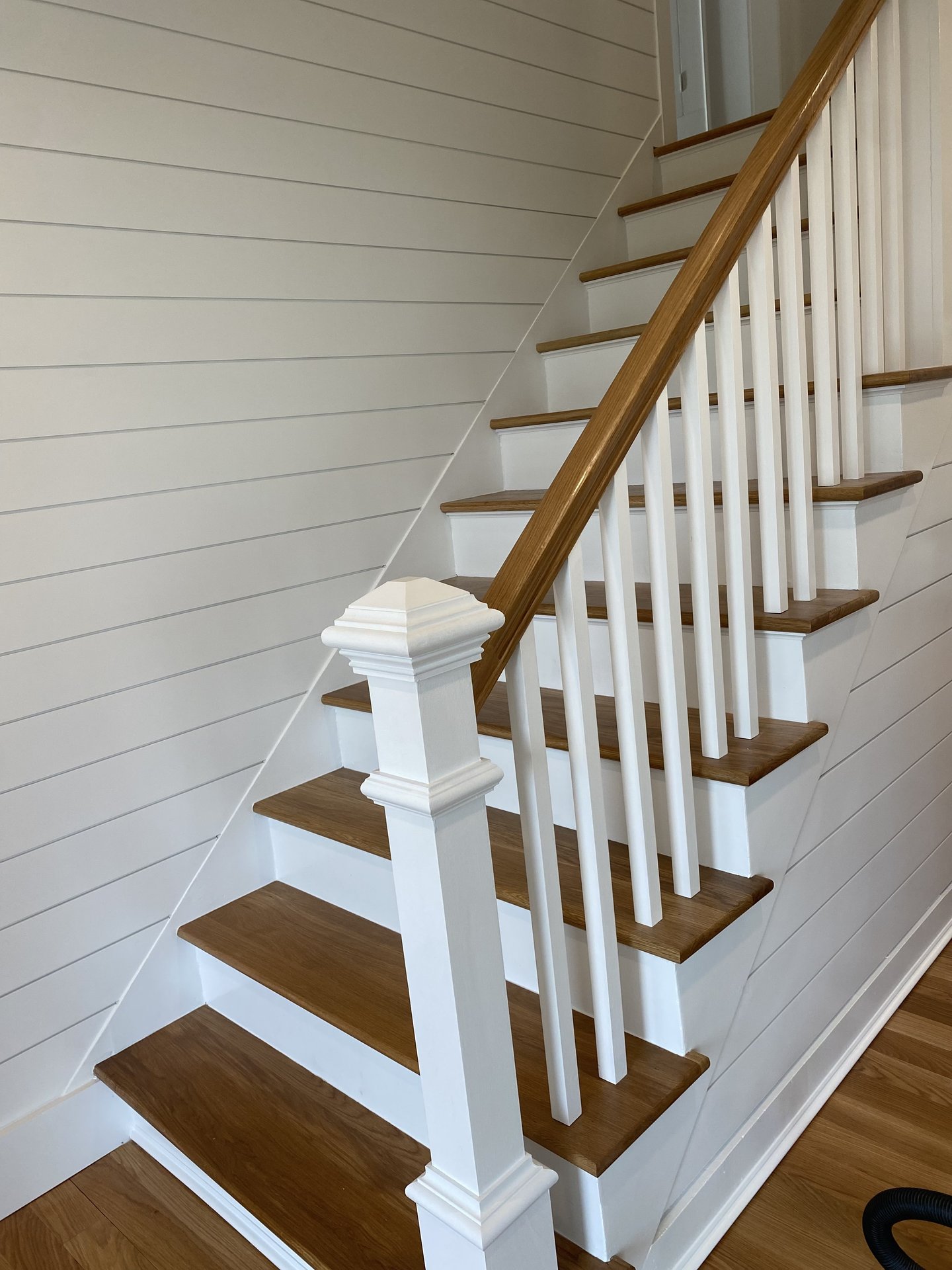 New staircase with white oak treads, painted risers and shiplap walls