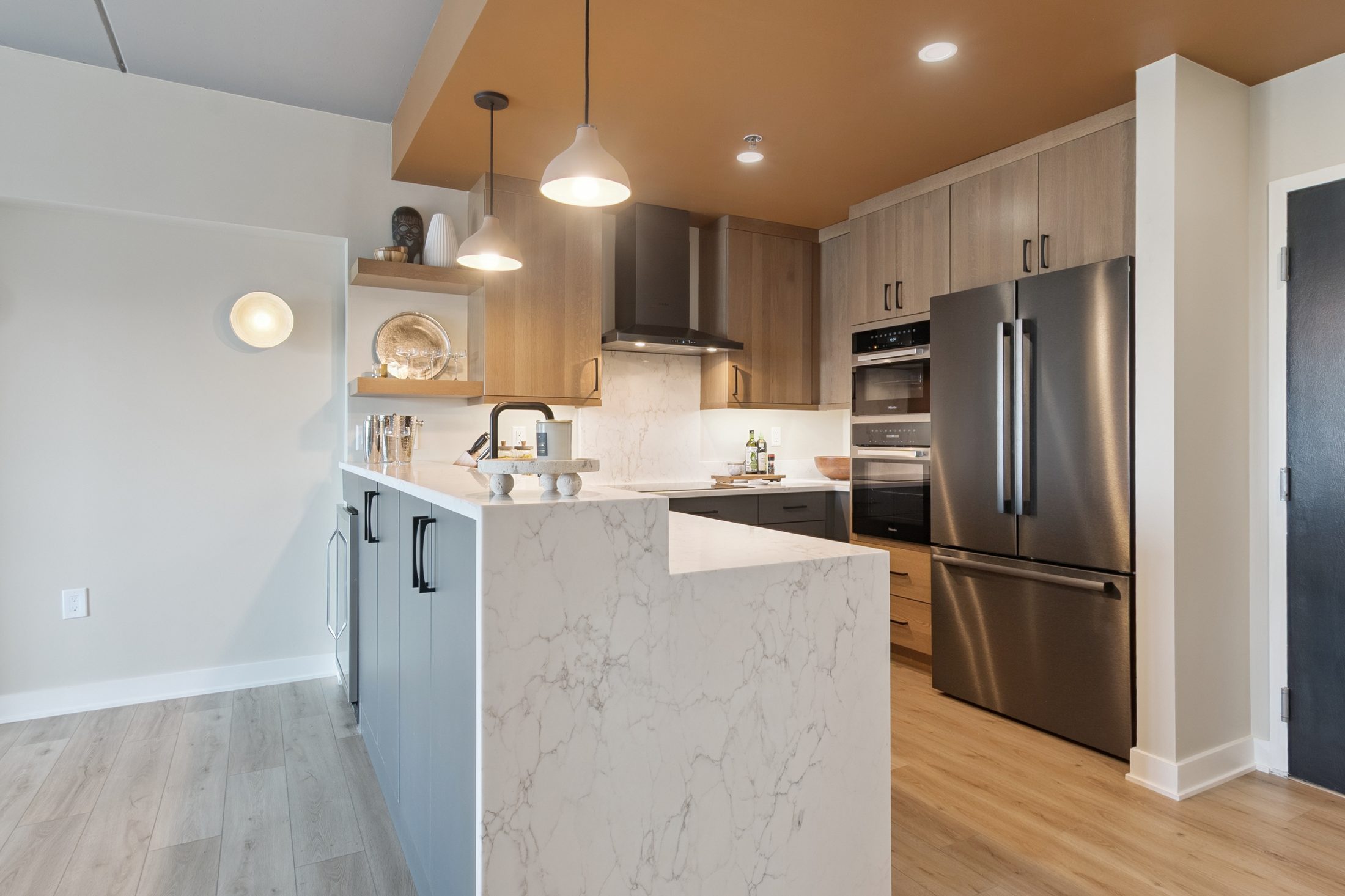 A warm modern kitchen remodel with waterfall island on North Ashley Street, Ann Arbor