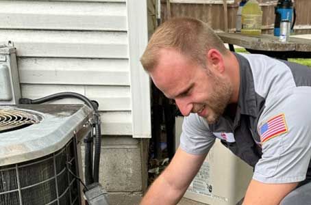 Plumbing Today technician servicing an AC condenser