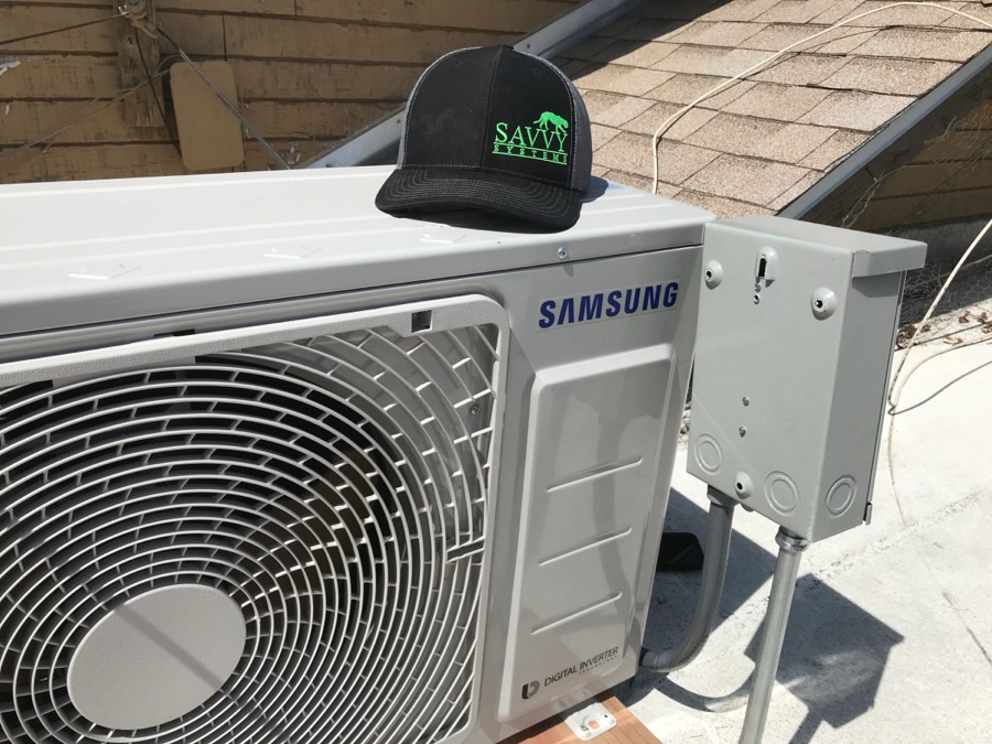 Savvy Systems hat on a freshly installed mini-split condenser
