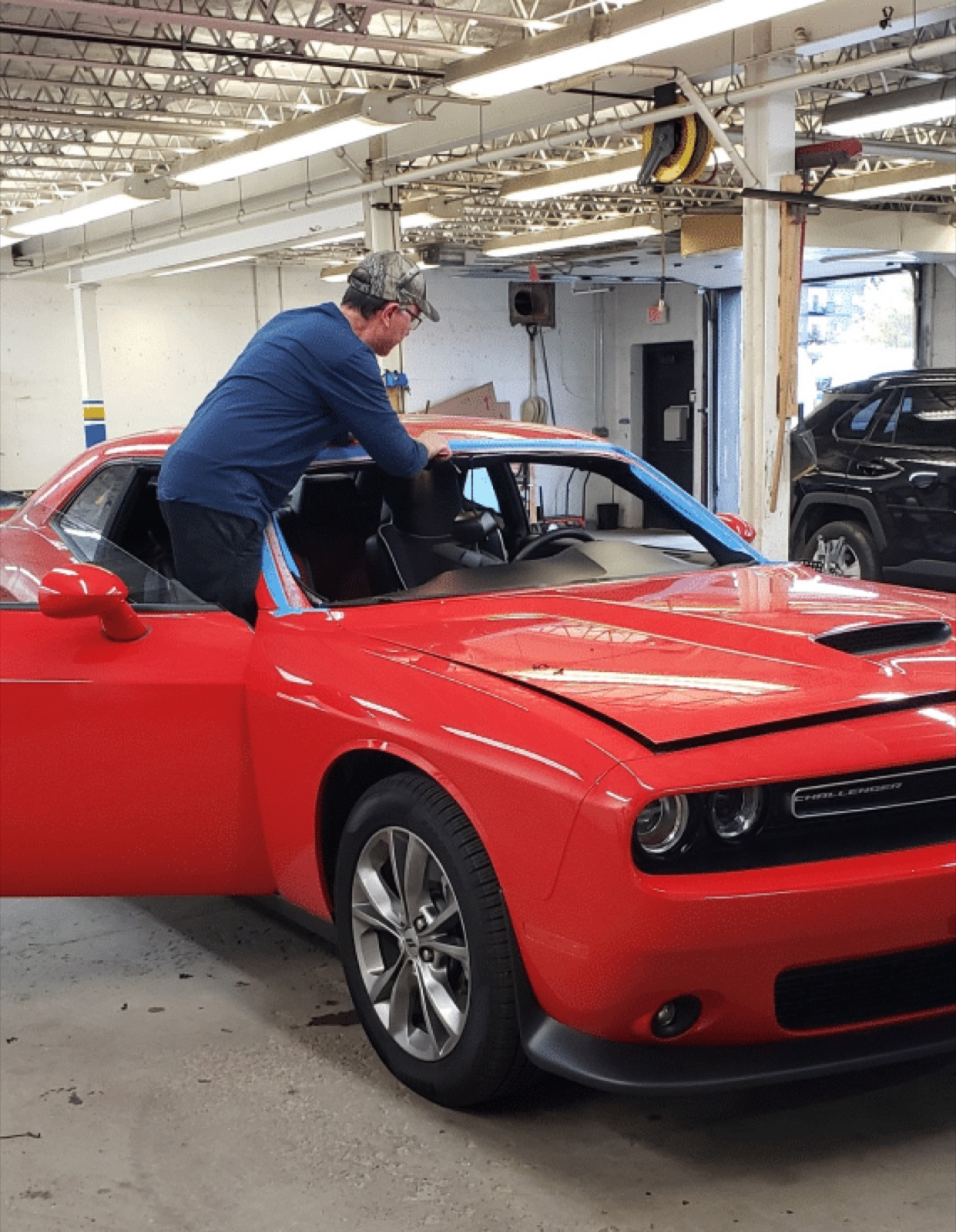 SGI technician replacing the windshield on a Dodge Challenger