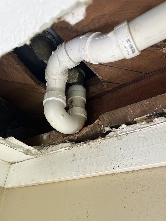 New PVC drain lines installed under a floor structure